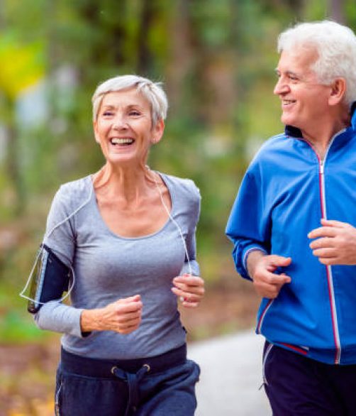 Senior active couple running, walking and talking in the park. Healthy lifestyle